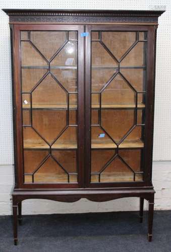 An Edwardian mahogany vitrine, the moulded and dentil cornic...