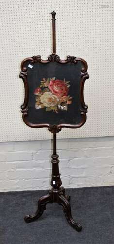 A Victorian rosewood pole screen with swept framed floral ne...