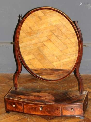 A George III mahogany toilet mirror, the oval plate within s...