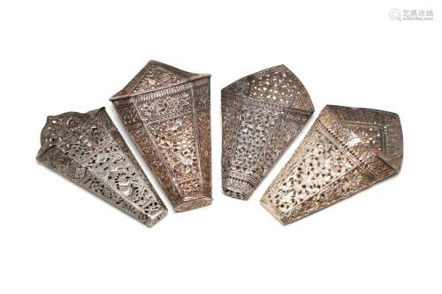 Four carved and repousse' silver betel leaf holders deco...