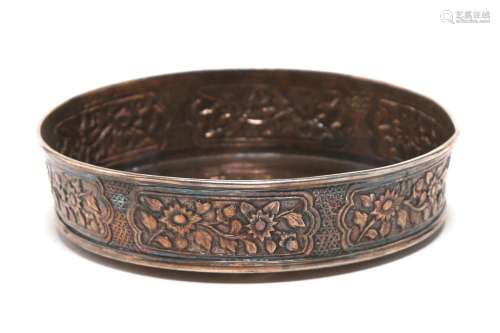A carved and repousse' silver small tray decorated in re...