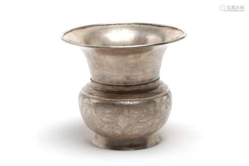 A carved and repousse' silver spittoon with a trumpet-mo...
