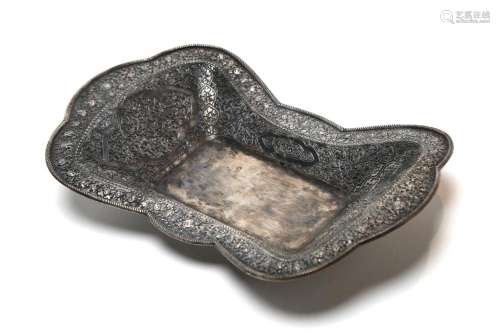 A carved and pierced silver tray decorated in relief with fl...