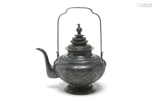 A carved and repousse' silver teapot with an upright han...