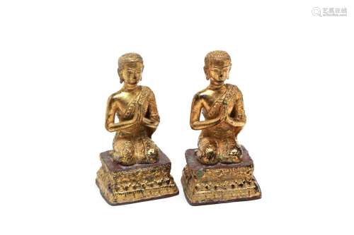 A pair of gilt bronze seated disciples