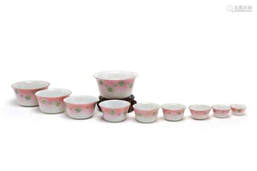 A group of porcelain medicine cups, each painted with flower...