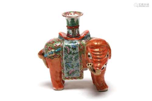 A polychrome porcelain candlestick in the form of elephant p...