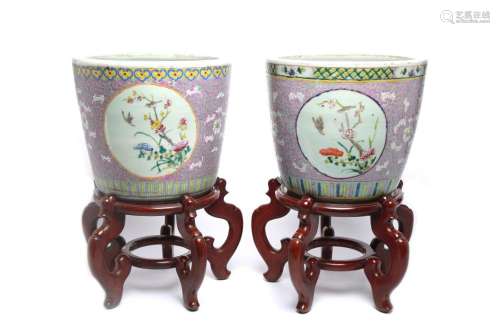 A pair of polychrome porcelain planters with wooden stands, ...