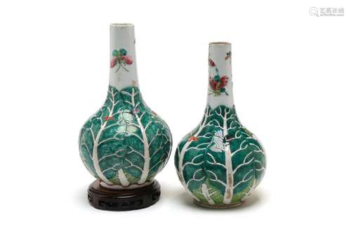 A pair of polychrome porcelain bottle vases, each painted wi...