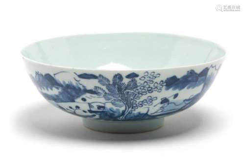 A blue and white porcelain bowl painted with landscape desig...