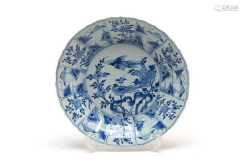 A large blue and white porcelain export dish painted with sc...