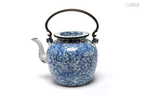 A blue and white porcelain teapot painted with a scrolling p...