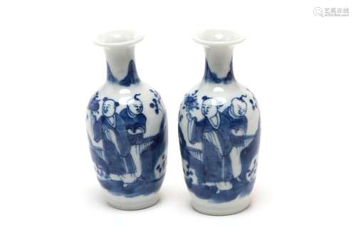 A pair of blue and white porcelain small vases, each painted...