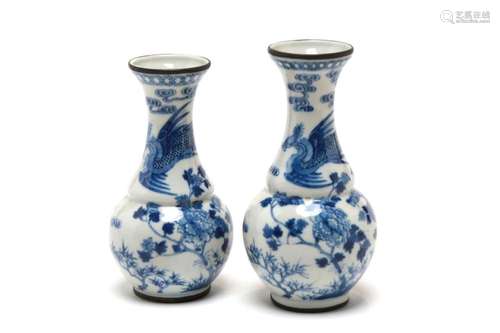 Two blue and white porcelain flared-mouth vases, each painte...