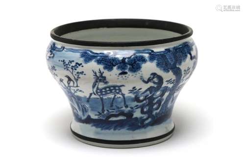 A blue and white porcelain spittoon painted with deer, monke...