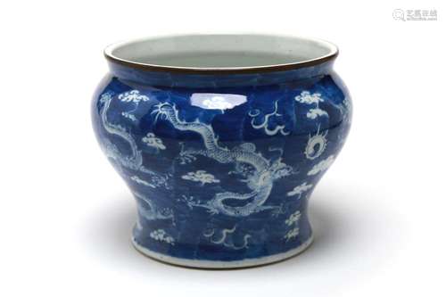 A blue and white porcelain spittoon painted with dragons wri...