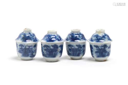 A miniature group of blue and white porcelain teacups, each ...