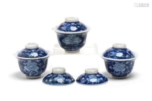 A miniature group of blue and white porcelain teacups, each ...