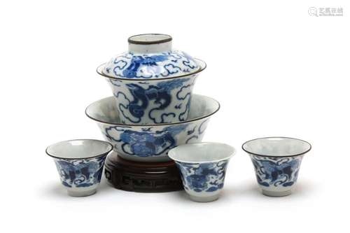 A blue and white porcelain tea set comprising of three teacu...