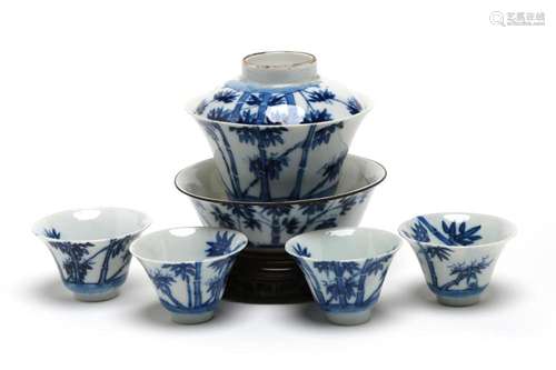 A blue and white porcelain tea set, comprising four teacups,...