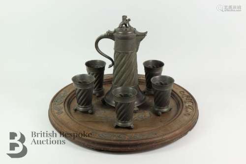 A large pewter lidded stein with five tumblers with wrythen