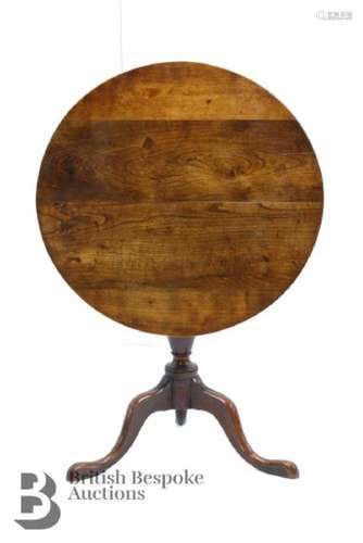 A four panel oak tilt top table, turned column on three spla