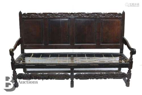 18th century oak settle, having a panelled back with a carve