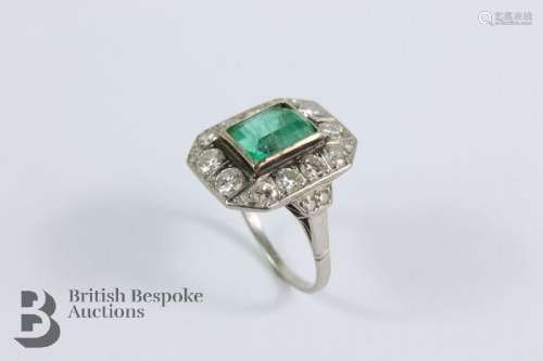 A period platinum Art Deco emerald and diamond ring. The rin