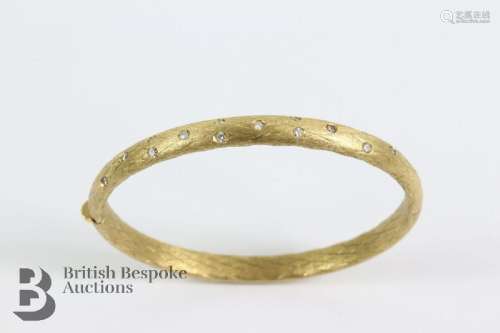 18ct yellow gold and diamond bangle. The burnished gold bang