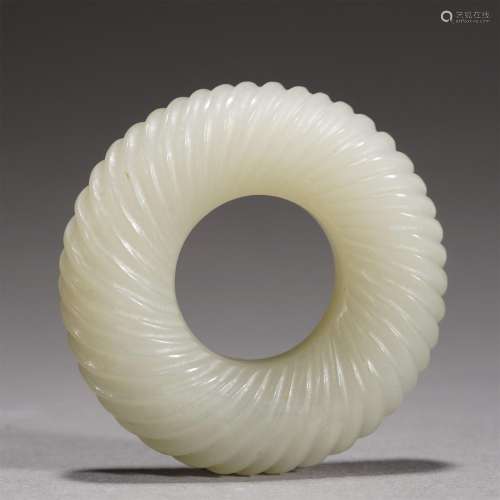 A CHINESE CARVED ORNAMENTAL JADE RING