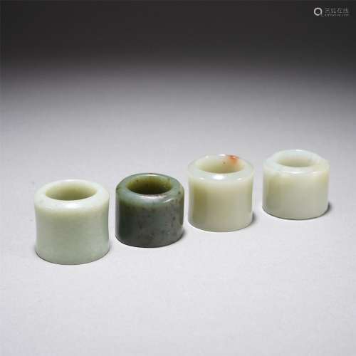 A SET OF FOUR CHINESE JADE ARCHERS RINGS
