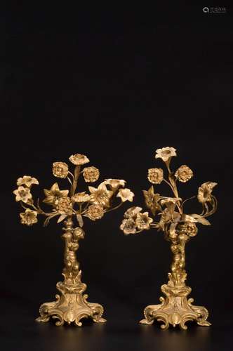 A PAIR OF GILT-COPPER CARVED CHILD AND ROSE CANDLESTICKS