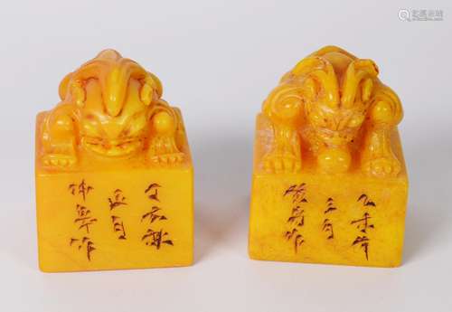 PAIR OF CHINESE YELLOW SOAPSTONE SEALS, the top handle of ea...