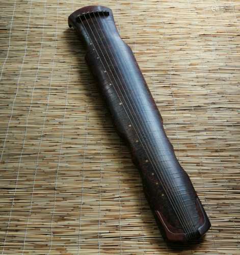 His wooden guqin:Paint jade-like stone embellish, there is w...