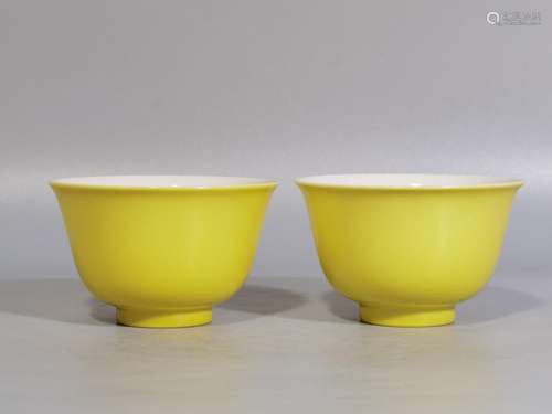 Lemon yellow glaze three fruit cup inside a pair of high cal...