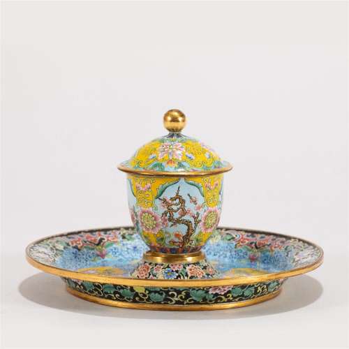 A PAINTED-ENAMEL TEA CUP WITH SAUCER