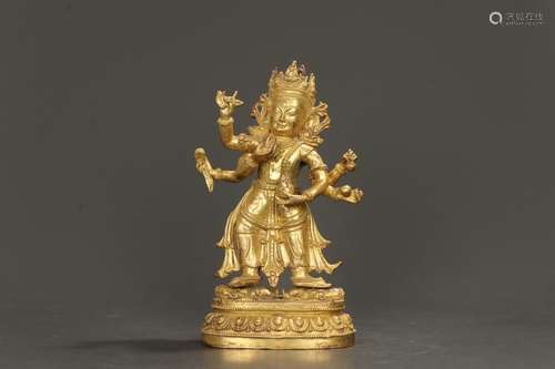 - copper and gold "six arm avalokitesvara statues stand...