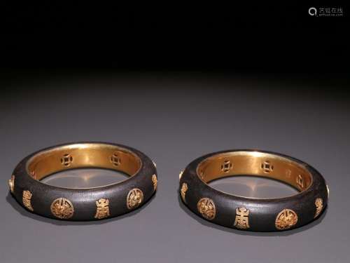 Night aloes, a pair of silver and gold inlaid shou wen brace...