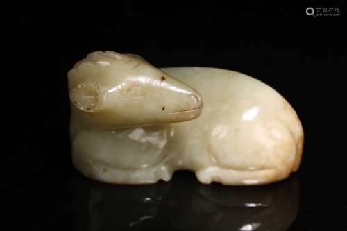 A CHINESE CELADON JADE CARVED RECUMBENT SHEEP