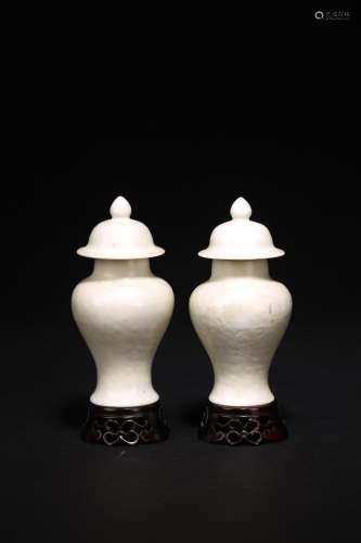 A PAIR OF WHITE GLAZED VASES AND COVER