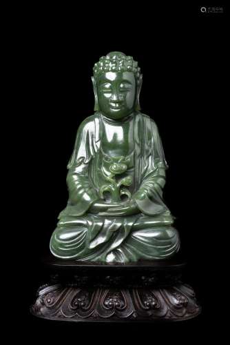 A SPINICH-GREEN JADE FIGURE OF MEDICINE MASTER BUDDHA IN QIN...