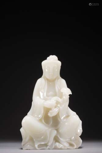 A WHITE JADE CARVED FIGURE OF GUANYIN WITH RUYI