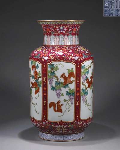 A red ground famille rose squirrel and grape porcelain vase