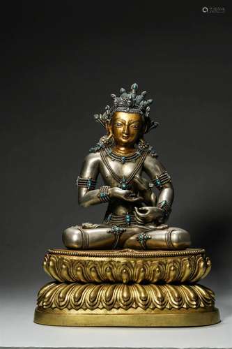 A gem-inlaid silver buddha statue