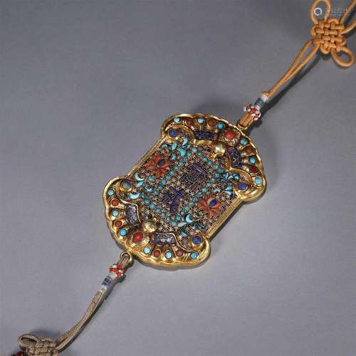 A gem-inlaid gold pendant