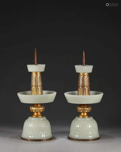 A pair of jade gold-inlaid lotus patterned candlesticks