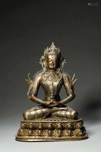 A gem-inlaid copper buddha statue