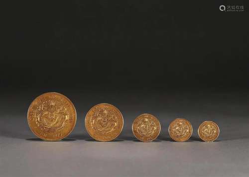 A set of 5 dragon patterned gold coins