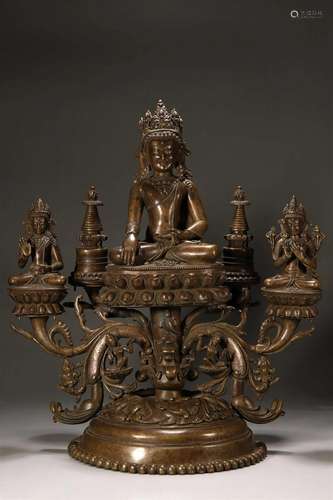 A silver-inlaid copper buddha statue