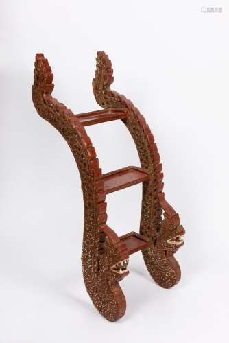 A carved wood step ladder with dragon supports. South East A...